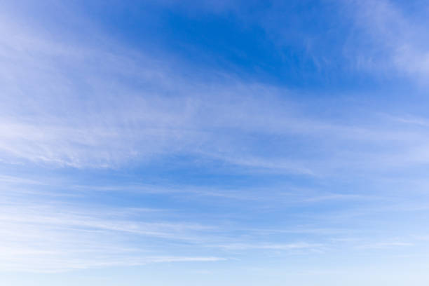 istock A serene view of a clear blue sky adorned with soft white clouds 2201715742
