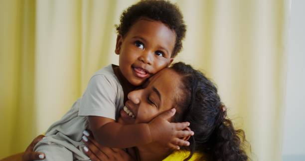 istock Mom and baby cuddle indoors 2201715828
