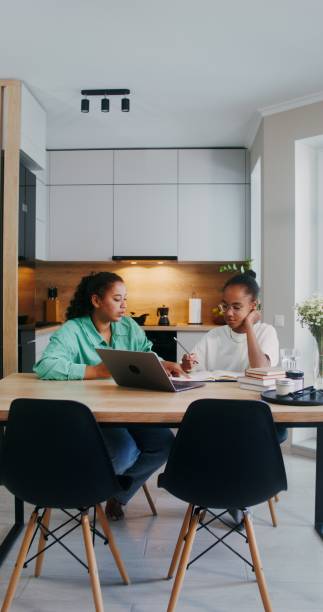 istock Mom helps her daughter do her homework 2201717000