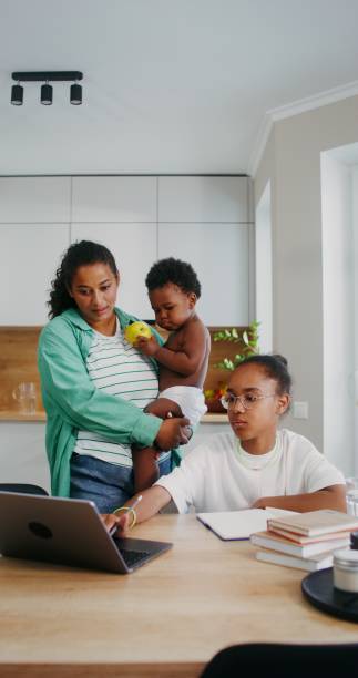 istock Mom helps her daughter do her homework 2201717311