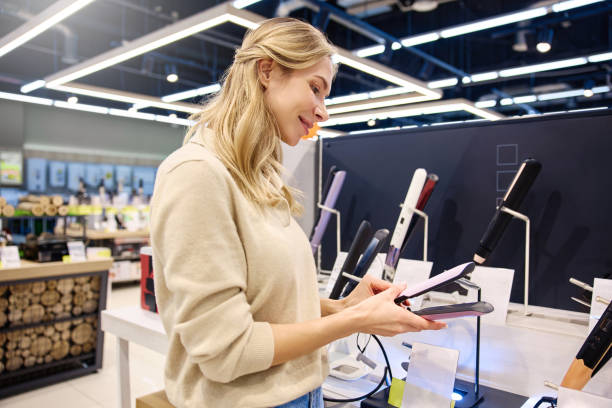istock A woman is selecting hair styling tools within a contemporary retail store environment 2201717811