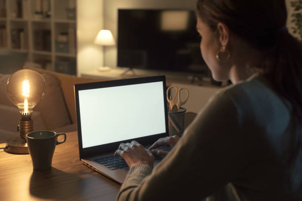 istock Woman working with her laptop at night 2201719496