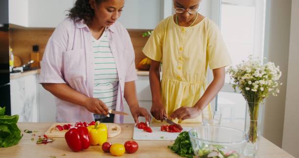 istock Mom and daughter cook in the kitchen 2201719670