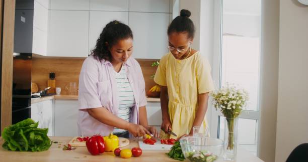 istock Mom and daughter cook in the kitchen 2201719695