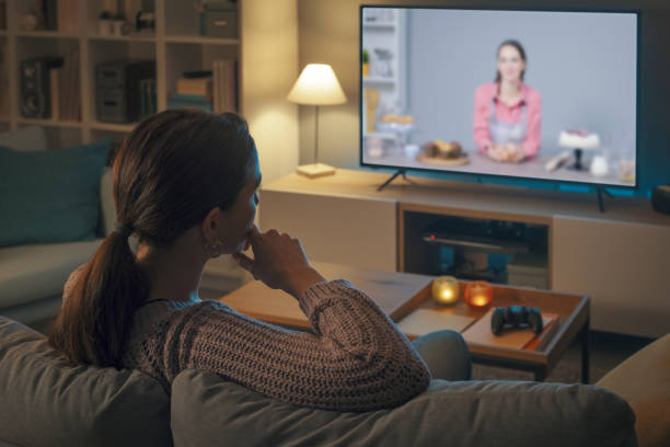 istock Woman watching a cooking show on TV 2201719803