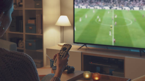 istock Woman watching a football game on TV 2201720125
