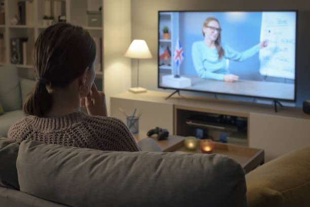 istock Woman learning English with TV shows 2201720319