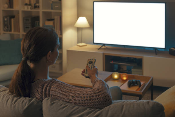 istock Woman watching TV and relaxing at home 2201720446