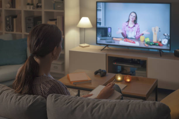 istock Woman watching a cooking show on TV 2201720590
