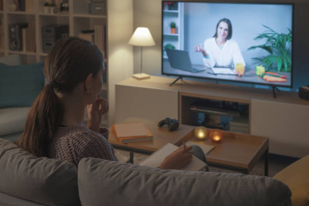istock Woman watching a nutritionist talking on the TV 2201720728