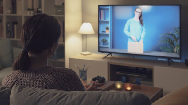 istock Woman watching an unboxing video on TV 2201720860