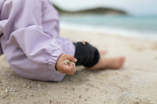 istock Sand in a girl's fist. 2201721399