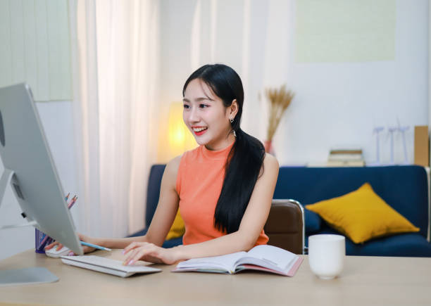 istock Woman smiling and having fun on laptop computer. Businesswoman going online using laptop computer, surfing the internet, online learning. 2201722005