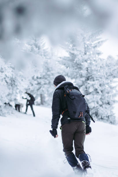 istock Young Man Hiking In Snow Covered Nature 2201723905