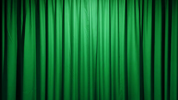 istock A luxurious, textured green fabric curtain, draped in soft folds and illuminated with a subtle glow, creates an elegant and versatile background suitable for stage curtains. 2201724357