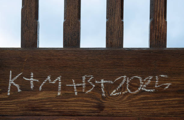 Sign written on the fence K+M+B+2025 from latin language Christus Mansionem Benedicat (Crist bless the house). Traditional sign on the door of christians. Kajov, Czech republic.