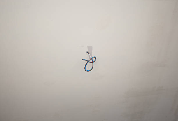 Electric wires emerge from the white ceiling.
