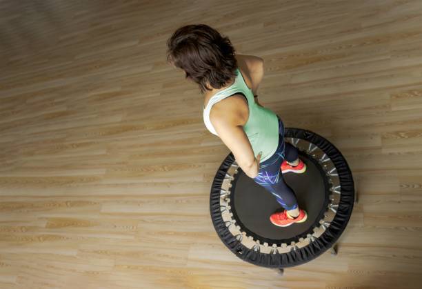 Woman Standing on Mini Trampoline Preparing for a Fitness Workout