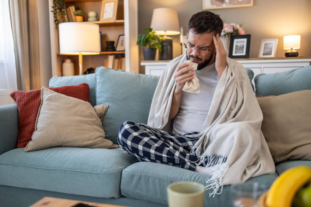 istock Young man with a runny nose and cold symptoms 2201727075
