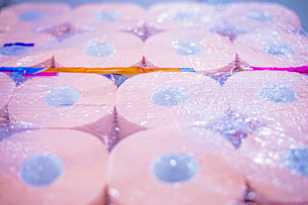pink packaged toilet paper in rolls. Intimate hygiene
