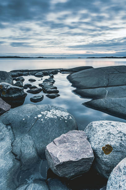 istock Coastal tranquility near Gothenburg features smooth rocks and reflective waters at dusk 2201729025