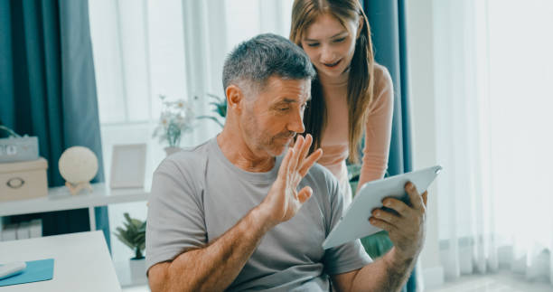 istock Senior father and daughter share a joyful moment as they make a video call on a digital tablet, emphasizing family bonding and technology use. Lifestyle family. 2201729420