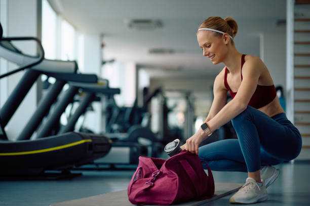 istock Happy athletic woman getting ready for exercise class in a gym. 2201729658