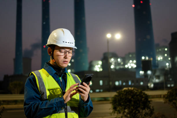 istock asian engineer using smart phone in power station at night 2201732523