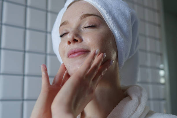 istock A Woman Is Delightfully Enjoying Her Skincare Routine in a Modern, Stylish Bathroom Space 2201733749