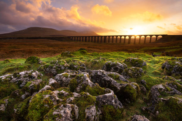 istock Dramatic Ribblehead Viaduct Sunset with Limestone Pavement, Yorkshire Dales, UK. 2201734557