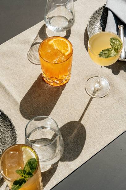 istock Top view of glasses containing different types of drinks placed on a cream-colored cloth. 2201737388
