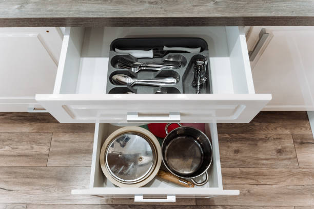 istock A kitchen drawer that is filled to the brim with various pots, pans, and an assortment of silverware, creating a useful and organized cooking space for culinary activities 2201737888