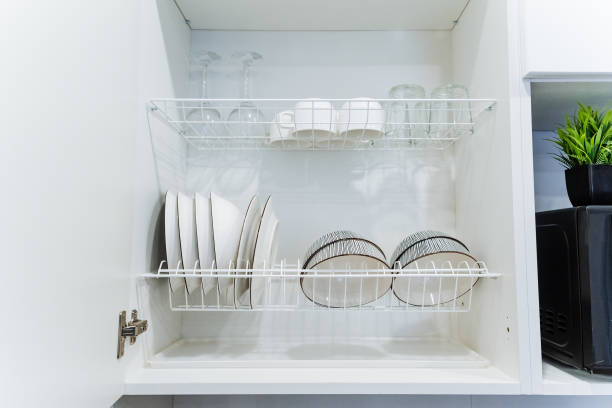 istock In the kitchen, a beautifully designed cabinet features a full dish rack with various dishes and glasses, showcasing an organized space for daily use and special occasions 2201737907