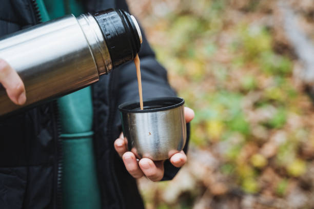 istock A person is skillfully pouring a steaming cup of coffee from a thermos into a white ceramic cup, showcasing their love for warm beverages during a possibly chilly morning or afternoon 2201737922