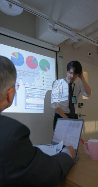 istock businessman do presentation in boardroom 2201740015