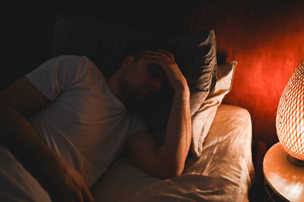 istock Worried man trying to sleep. 2201740045