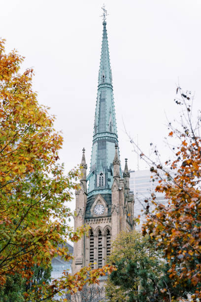 istock Beautiful Church Steeple Enveloped by Colorful Autumn Trees 2201740166