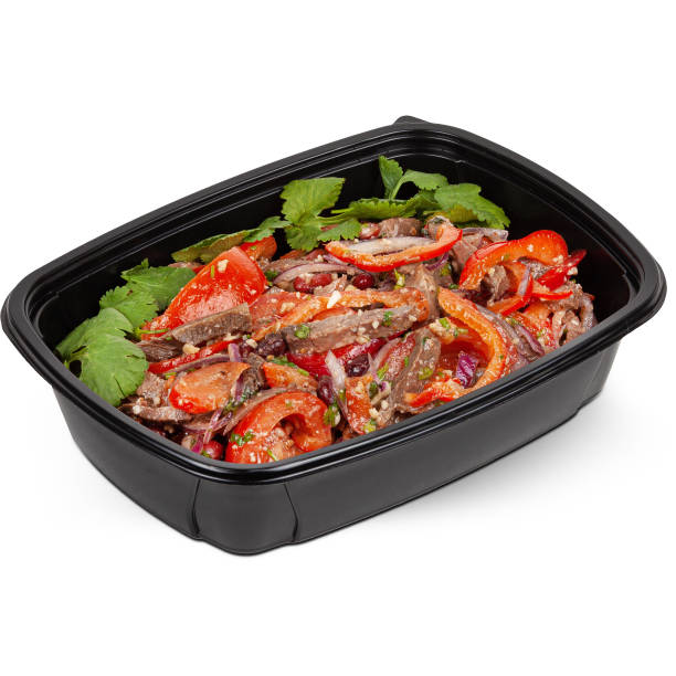 istock Salad with tomatoes, onions and beef in a black plastic lunchbox photo on a white background 2201740671