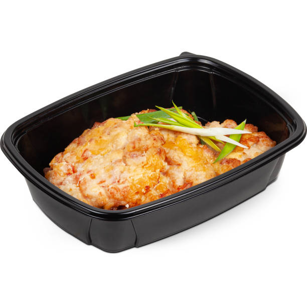 istock Crispy breaded bacon patty in a black plastic lunchbox photo on a white background 2201741968