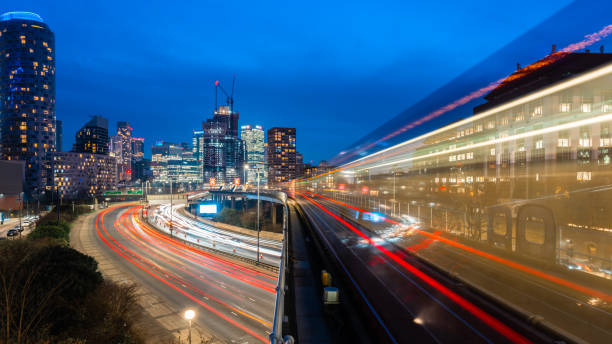 istock Light trails from traffic and the docklands light railway in london at twilight 2201742847