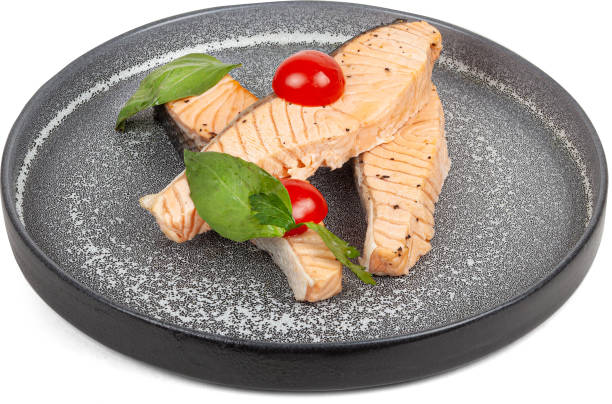 istock Steamed salmon with cherry tomatoes on a plate on a white background 2201742877