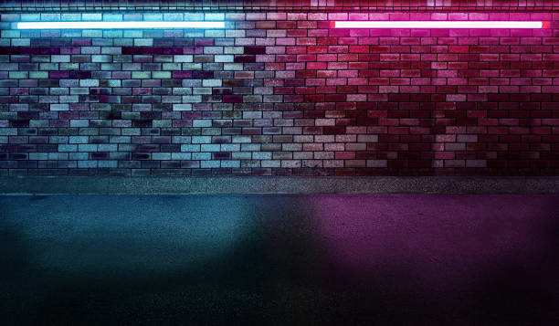istock Blue and purple neon light bulbs on old dark brick background. 2201744958