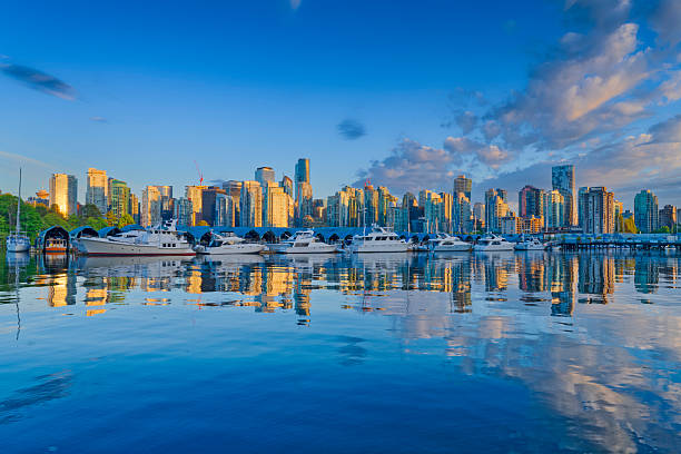 Downtown view of Vancouver from Coal Harbor and Burrard Inlet at sunset, British Columbia