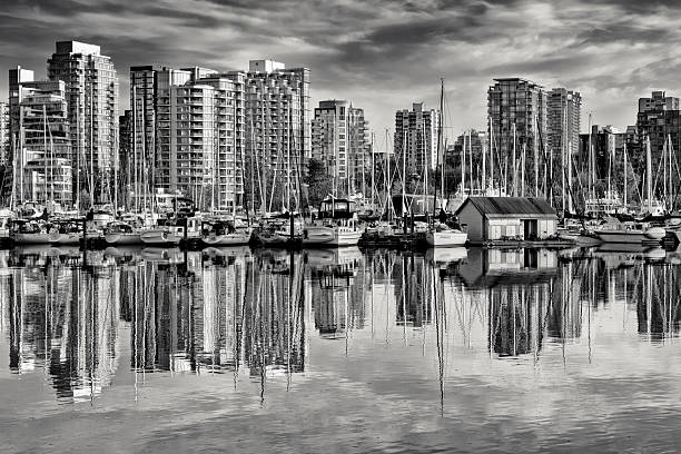 Downtown view of Vancouver from Coal Harbor and Burrard Inlet at sunset, British Columbia