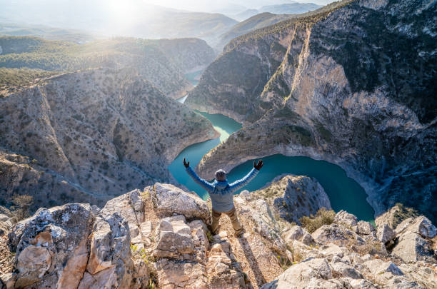 istock Mountain climber man is raising his arms  while watching the beautiful Arapapisti incegiz canyon in Aydın , Denizli 2201746647