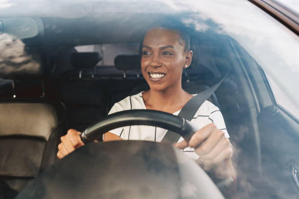 istock Happy woman driving a car 2201747459