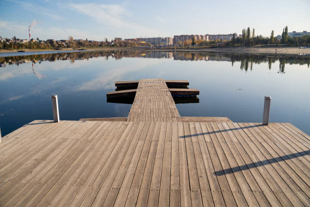 istock A beautifully crafted wooden dock gracefully extends into the crystalclear water, creating a serene and picturesque scene that truly embodies the essence of nature and harmony all around 2201748045