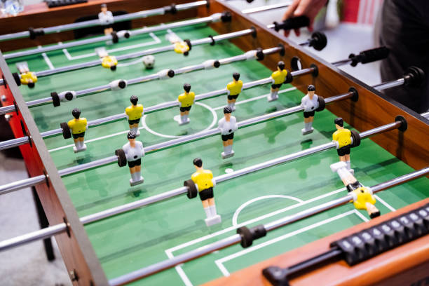 istock A person is actively engaged in playing a foosball game on a specially designed table meant for this exciting activity, showcasing skills and strategies in a friendly competition 2201748048