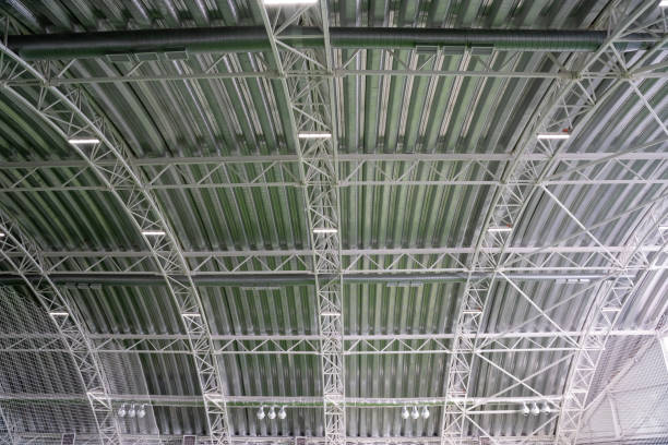 istock The buildings exceptionally spacious ceiling boasts intricate metal beams that contribute to a unique architectural design while effectively providing support for the entire roof structure 2201748098
