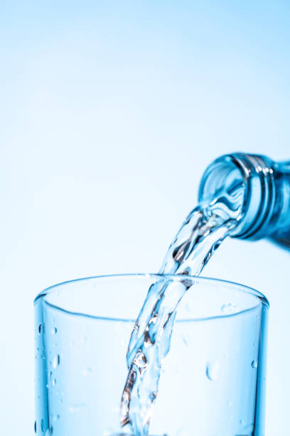 istock Crystal clear water being poured into a transparent glass, creating refreshing ripples and bubbles 2201748590